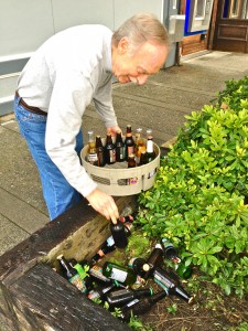 Chris Smith retrieves 34 bottles of beer from the planter out back.