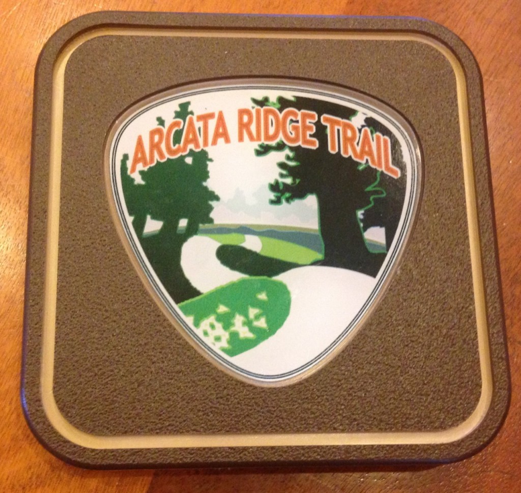 Five of these collectible Arcata Ridge Trail markers, with the logo designed by Dave Held, will be available for $65 each.
