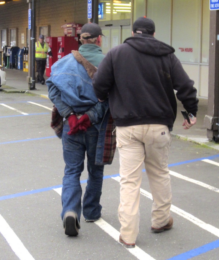 James Burke of Galt, Calif. is taken into custody by APD Officer Richard Bergstresser after allegedly purchasing alcohol for a minor and being in possession of a cell phone charger stolen from CVS Pharmacy. Burke had a warrant out for is arrest after violating supervised parole. According to APD, his parole stemmed from a prior conviction for possession of stolen property. KLH | Eye
