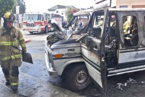 Firefighters clean up after extinguishing the van. Photos by Bryn Robertson