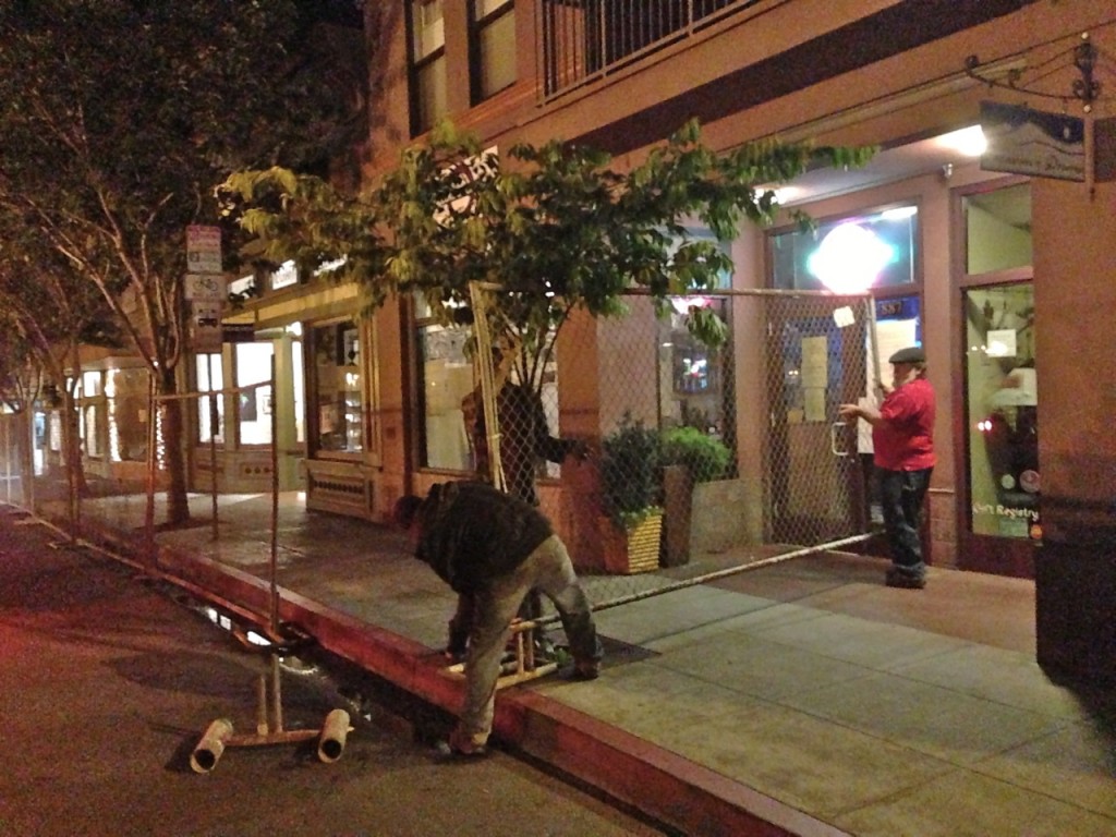 Workers from the Craftsman's Mall install the OysterFence in the early morning hours of June 15. KLH | Eye
